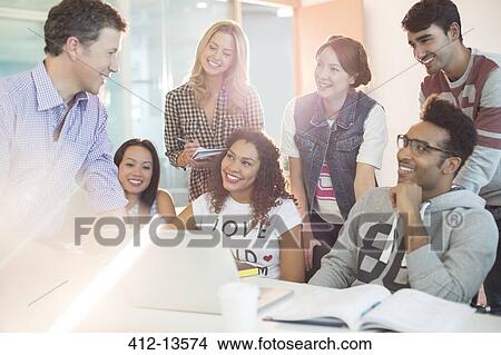 Picture - University students talking with teacher in classroom. Fotosearch
