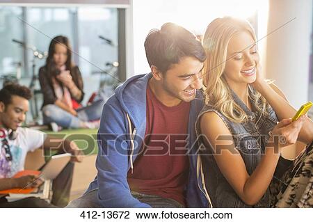 University students using cell phone in lounge View Large Photo Image Stock Image - University students using cell phone in lounge. Fotosearch