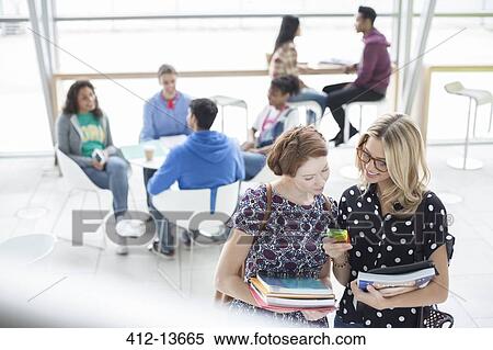 University students using cell phone in cafe View Large Photo Image Stock Photography - University students using cell phone in cafe. Fotosearch
