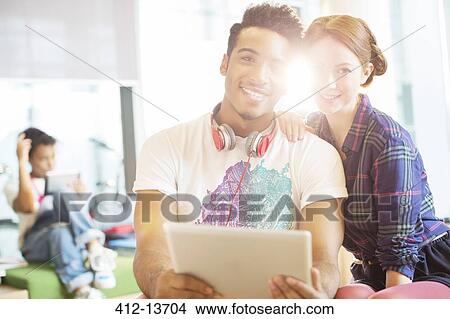 University students using digital tablet in lounge View Large Photo Image Picture - University students using digital tablet in lounge. Fotosearch