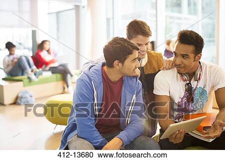 University students using digital tablet in lounge View Large Photo Image Stock Image - University students using digital tablet in lounge. Fotosearch