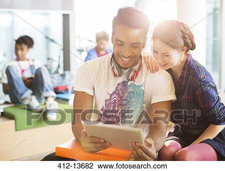 University students using digital tablet in lounge View Large Photo Image Stock Image - University students using digital tablet in lounge. Fotosearch