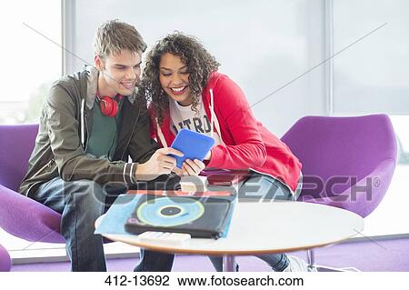 University students using digital tablet in lounge View Large Photo Image Stock Image - University students using digital tablet in lounge. Fotosearch