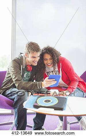 University students using digital tablet in lounge View Large Photo Image Stock Photo - University students using digital tablet in lounge. Fotosearch