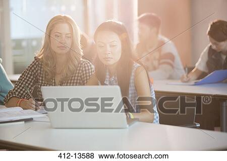 University students using laptop in classroom View Large Photo Image Stock Photo - University students using laptop in classroom. Fotosearch