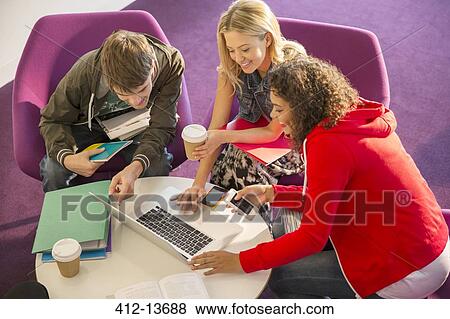 University students using laptop in lounge View Large Photo Image Stock Photo - University students using laptop in lounge. Fotosearch