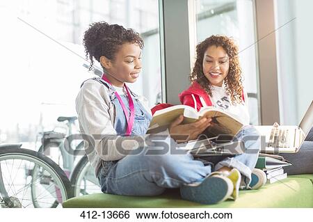 University students working together on bench View Large Photo Image Stock Photograph - University students working together on bench. Fotosearch