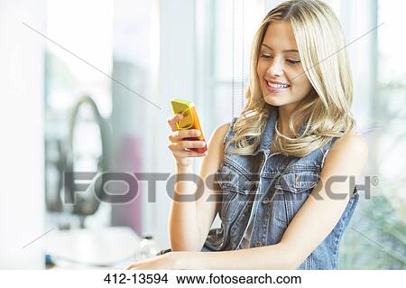 Picture - Woman using cell phone. Fotosearch
