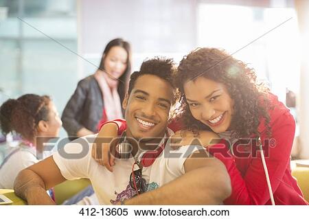 Young couple smiling in student lounge View Large Photo Image Stock Photography - Young couple smiling in student lounge. Fotosearch