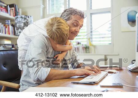 Boy hugging working father View Large Photo Image Stock Image - Boy hugging working father. Fotosearch