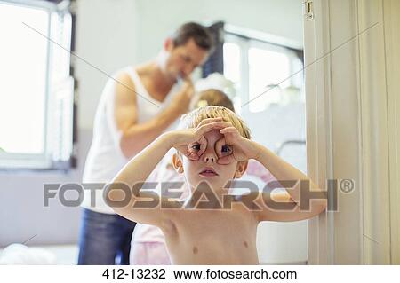 Stock Image - Boy making face in bathroom. Fotosearch