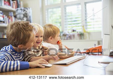 Children using home office together View Large Photo Image Stock Photo - Children using home office together. Fotosearch