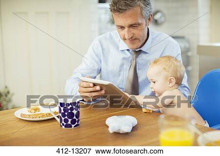 Stock Photo - Father and baby using digital tablet. Fotosearch
