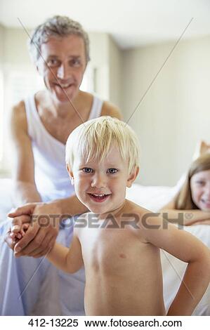 Father and children on bed View Large Photo Image Stock Photography - Father and children on bed. Fotosearch