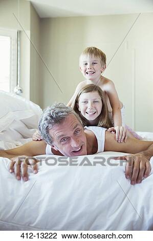 Father and children playing on bed View Large Photo Image Stock Image - Father and children playing on bed. Fotosearch