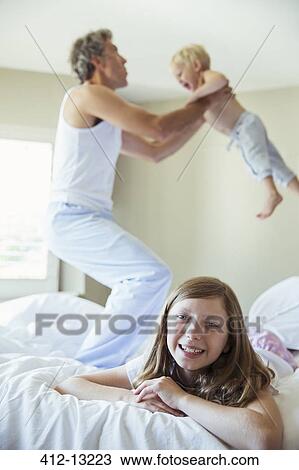Father and children playing on bed View Large Photo Image Stock Image - Father and children playing on bed. Fotosearch