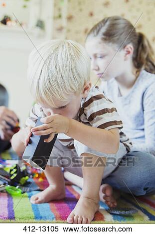 Stock Photography - Father and children playing together. Fotosearch