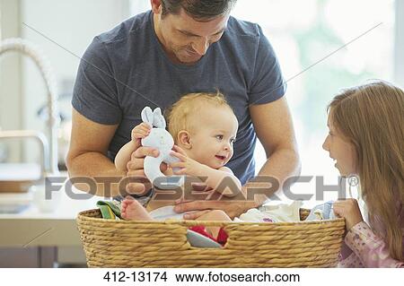 Father and children sorting laundry View Large Photo Image Picture - Father and children sorting laundry. Fotosearch