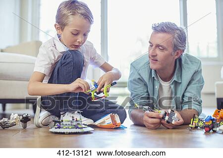 Father and son playing together View Large Photo Image Stock Image - Father and son playing together. Fotosearch