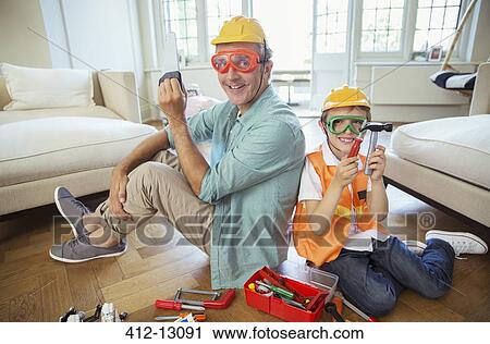 Stock Image - Father and son playing with construction toys. Fotosearch