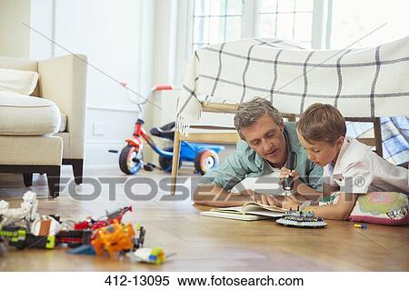 Father and son reading together View Large Photo Image Stock Photography - Father and son reading together. Fotosearch