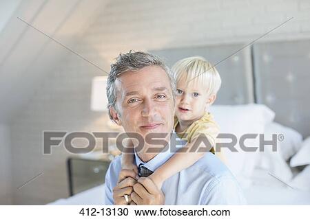 Father carrying son piggyback View Large Photo Image Stock Image - Father carrying son piggyback. Fotosearch