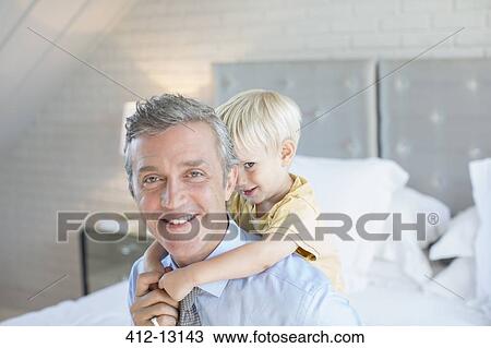 Father carrying son piggyback View Large Photo Image Stock Image - Father carrying son piggyback. Fotosearch