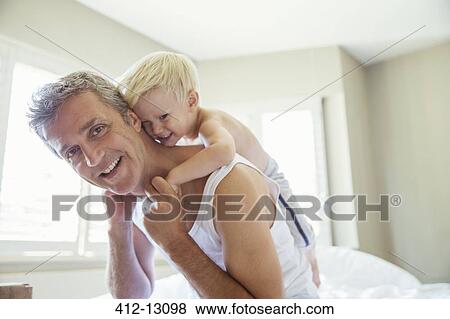 Father carrying son piggyback View Large Photo Image Stock Photo - Father carrying son piggyback. Fotosearch