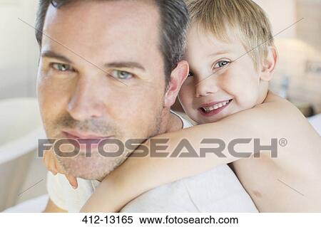 Stock Photography - Father carrying son piggyback. Fotosearch
