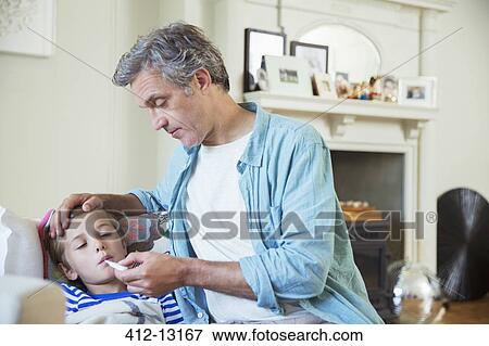 Father checking son's temperature View Large Photo Image Stock Photo - Father checking son's temperature. Fotosearch