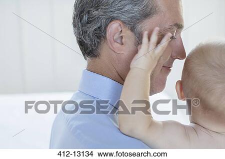 Father holding baby in bathroom View Large Photo Image Picture - Father holding baby in bathroom. Fotosearch