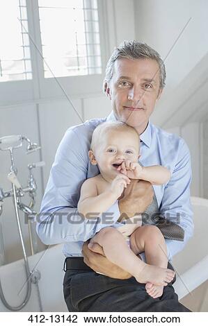 Father holding baby in bathroom View Large Photo Image Stock Image - Father holding baby in bathroom. Fotosearch