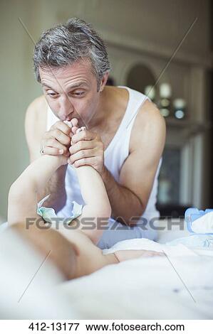 Father kissing baby's feet View Large Photo Image Stock Photo - Father kissing baby's feet. Fotosearch