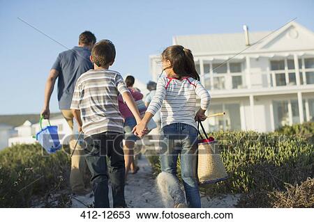 Brother and sister holding hands on beach path View Large Photo Image Stock Image - Brother and sister holding hands on beach path. Fotosearch