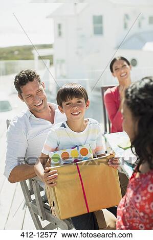 Family celebrating birthday on sunny patio View Large Photo Image Stock Photo - Family celebrating birthday on sunny patio. Fotosearch