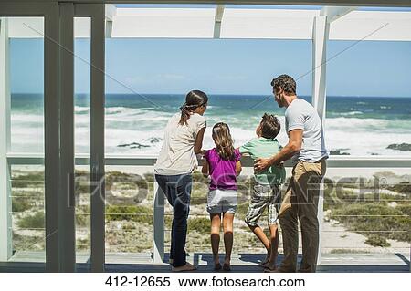 Family enjoying ocean view from patio View Large Photo Image Stock Photography - Family enjoying ocean view from patio. Fotosearch