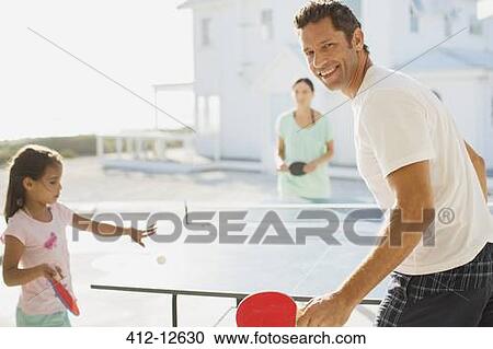 Family playing table tennis outside house View Large Photo Image Stock Image - Family playing table tennis outside house. Fotosearch