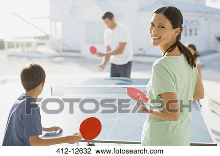 Family playing table tennis together outdoors View Large Photo Image Stock Image - Family playing table tennis together outdoors. Fotosearch