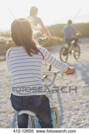 Family riding bicycles on sunny beach View Large Photo Image Stock Photography - Family riding bicycles on sunny beach. Fotosearch