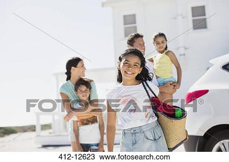 Family smiling in sunny driveway View Large Photo Image Stock Image - Family smiling in sunny driveway. Fotosearch
