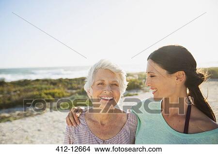 Picture - Mother and daughter on sunny beach. Fotosearch