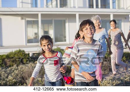 Multi-generation family on beach path outside house View Large Photo Image Stock Photography - Multi-generation family on beach path outside house. Fotosearch