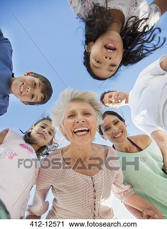 Multi-generation family smiling in huddle View Large Photo Image Stock Image - Multi-generation family smiling in huddle. Fotosearch