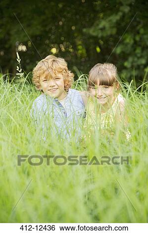 Children playing in tall grass View Large Photo Image Stock Photograph - Children playing in tall grass. Fotosearch