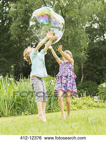 Children playing with bubble outdoors View Large Photo Image Stock Photograph - Children playing with bubble outdoors. Fotosearch