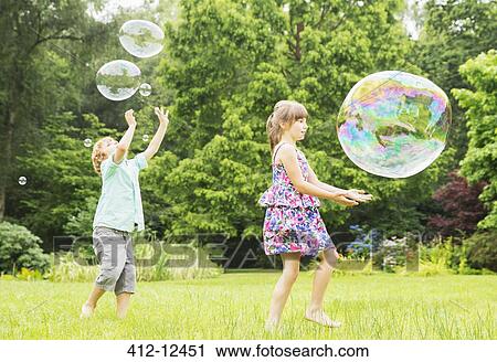 Children playing with bubbles outdoors View Large Photo Image Stock Image - Children playing with bubbles outdoors. Fotosearch