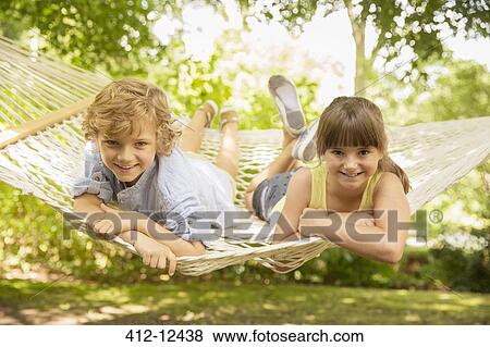 Stock Photo - Children relaxing together in hammock. Fotosearch