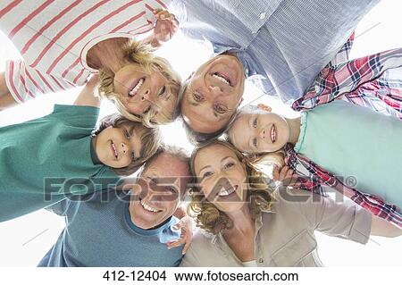 Picture - Family smiling together outdoors. Fotosearch
