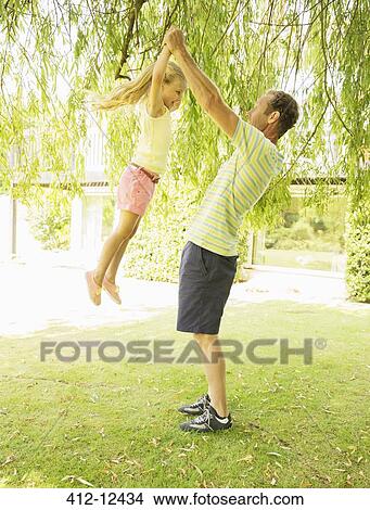 Father and daughter playing outdoors View Large Photo Image Picture - Father and daughter playing outdoors. Fotosearch