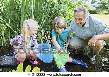 Grandfather and grandchildren fishing with nets View Large Photo Image Stock Image - Grandfather and grandchildren fishing with nets. Fotosearch